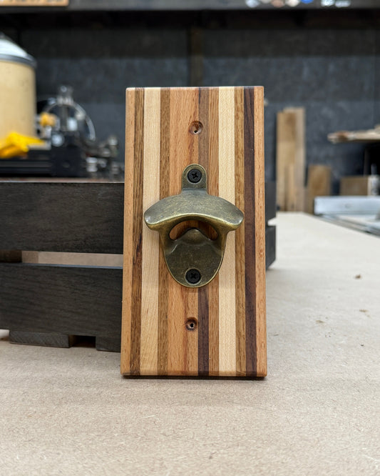 Wooden bottle opener with metal cap catcher on a counter