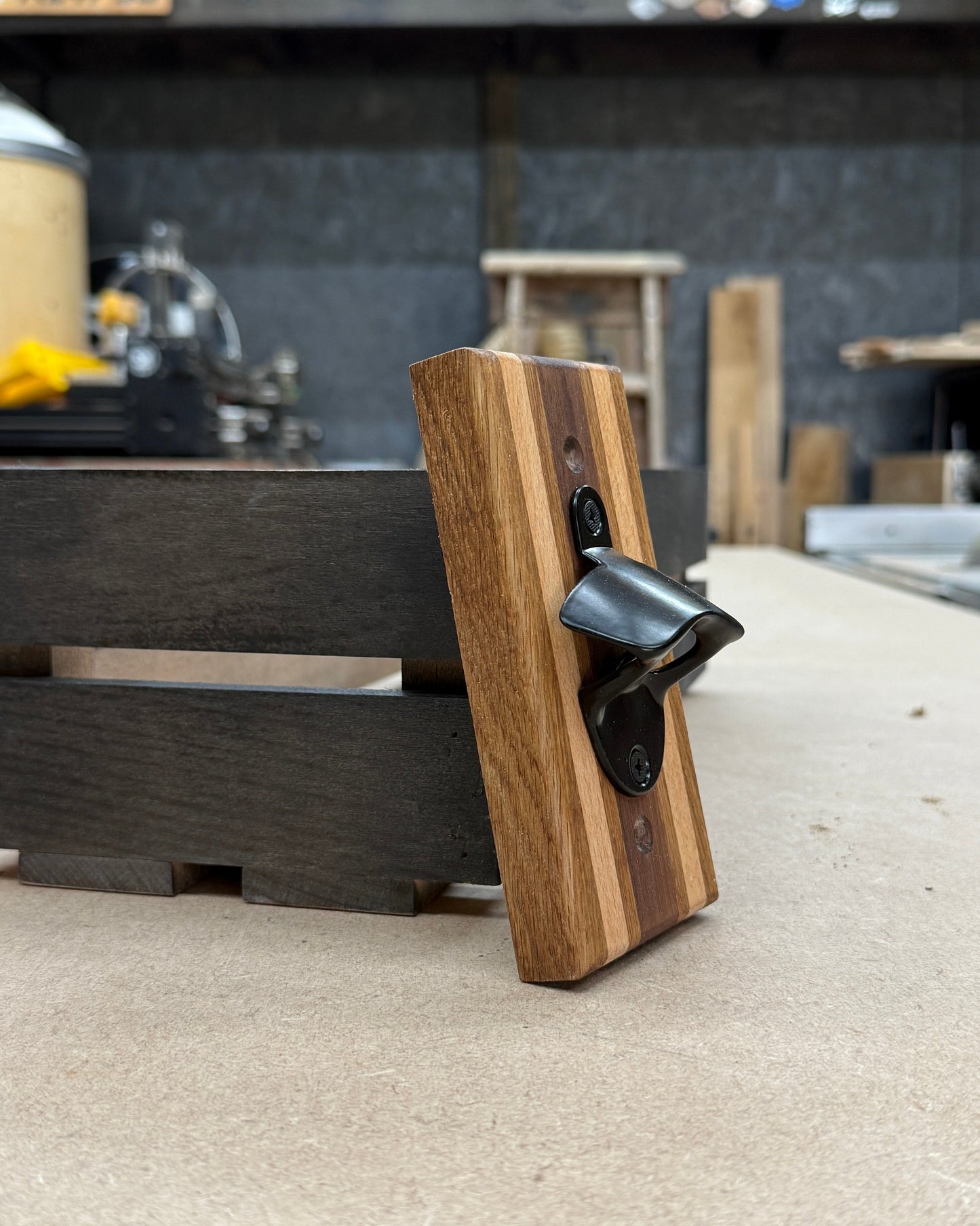 Wooden bottle opener on a counter with blurred background
